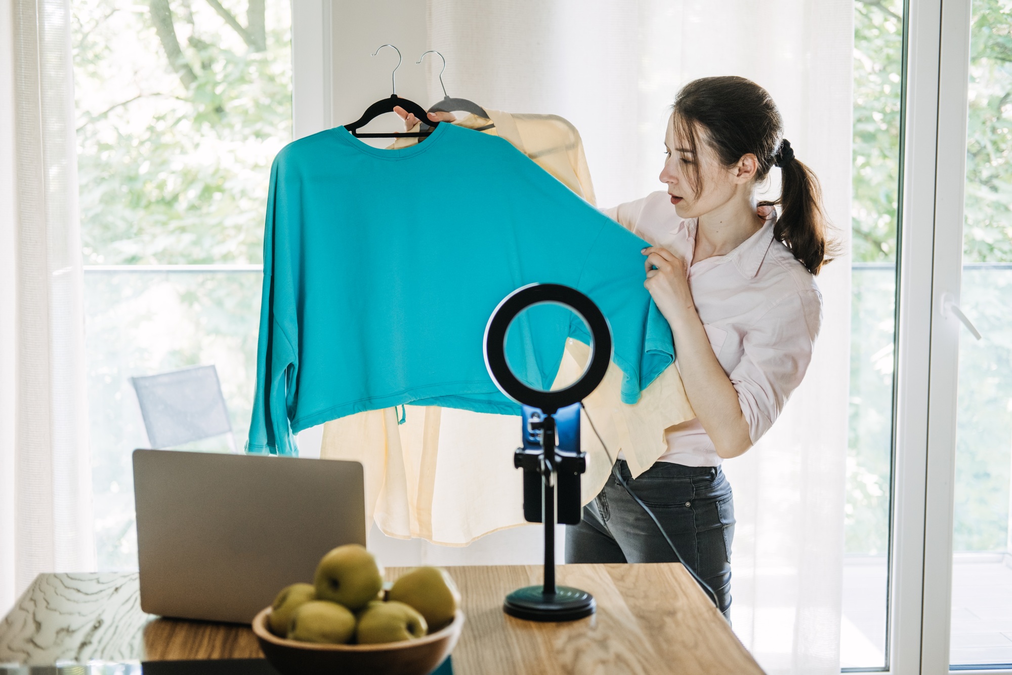 Fashion blogger showcasing outfits during live stream, content creation, influencer marketing